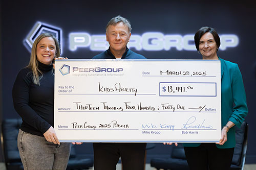PEER Group presenting donation cheque to Kidsability in March 2025